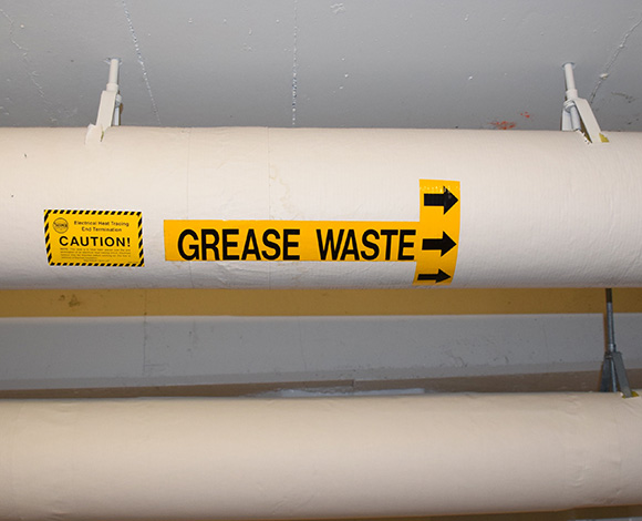 Grease trap discharge line for commercial waste trap grease pumping